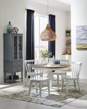 Beacon 48 inch round pedestal table in Sandstone and Chalk with Zealand chairs in Chalk and the Emma Display Cabinet in Smoke - Barewood